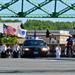 Flag bearing honor guard crossing a bridge.