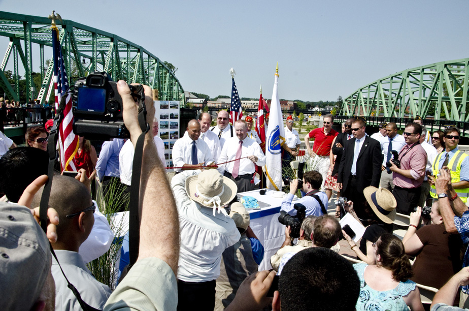 Dignitaries cut a ribbon.